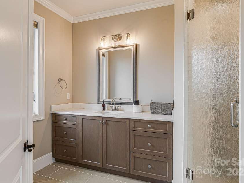 360 Turkey Branch Road, Mars Hill, NC 28754.  MLS# CAR4218460, YatesRealty ID 1586. Ensuite bathroom for 2nd main level bedroom with tiled shower.