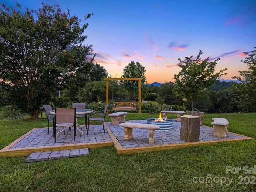 360 Turkey Branch Road, Mars Hill, NC 28754.  MLS# CAR4218460, YatesRealty ID 1586. Outdoor seating under the stars w/ firepit. Fenced in garden.
