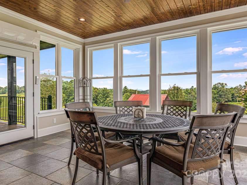 360 Turkey Branch Road, Mars Hill, NC 28754.  MLS# CAR4218460, YatesRealty ID 1586. Sunroom with surround windows overlooking the backyard. Extra heating & cooling system