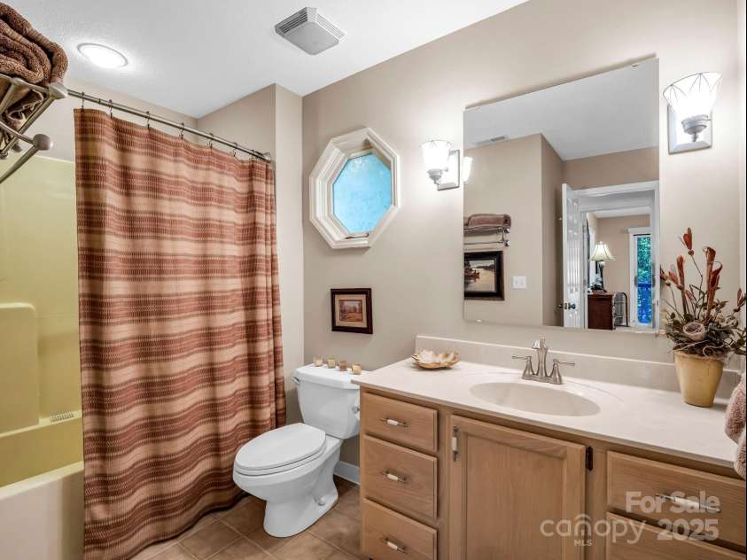 193 Downing Place, Lake Lure, NC 28746.  MLS# CAR4280208, YatesRealty ID 1588. Guest bath on the main level, accessible from the hallway and guest bedroom.