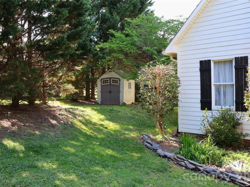 2325 Perry Road, Denver, NC 28037.  MLS# CAR4372829, YatesRealty ID 15892. Left Side View with Shed and stone edged front landscaping enhancement