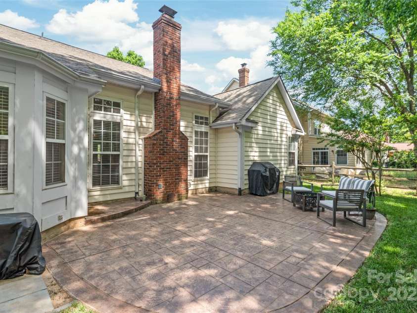 936 Knightsbridge Road, Fort Mill, SC 29708.  MLS# CAR4260474, YatesRealty ID 15896. This spacious stamped concrete patio offers plenty of room for outdoor furniture, grilling, and gathering—your ideal backyard hangout.