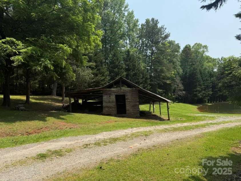620 Smith Waldrop Road, Columbus, NC 28722.  MLS# CAR4209729, YatesRealty ID 15909. Approach to guest cabin & spring-fed pond!