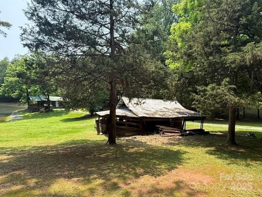 620 Smith Waldrop Road, Columbus, NC 28722.  MLS# CAR4209729, YatesRealty ID 15909. Guest cabin & pond area with old barn on good building site.
