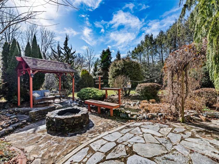 149 Southbrook Lane, Fletcher, NC 28732.  MLS# CAR4221393, YatesRealty ID 15918. A lovely secret garden with a gazebo, firepit and handsome stonework.  A perfect spot to enjoy the end of a busy week.
