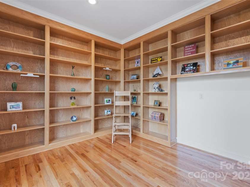 149 Southbrook Lane, Fletcher, NC 28732.  MLS# CAR4221393, YatesRealty ID 15918. Bespoke bookshelves create a warmth to make this room perfect for a home library or office.