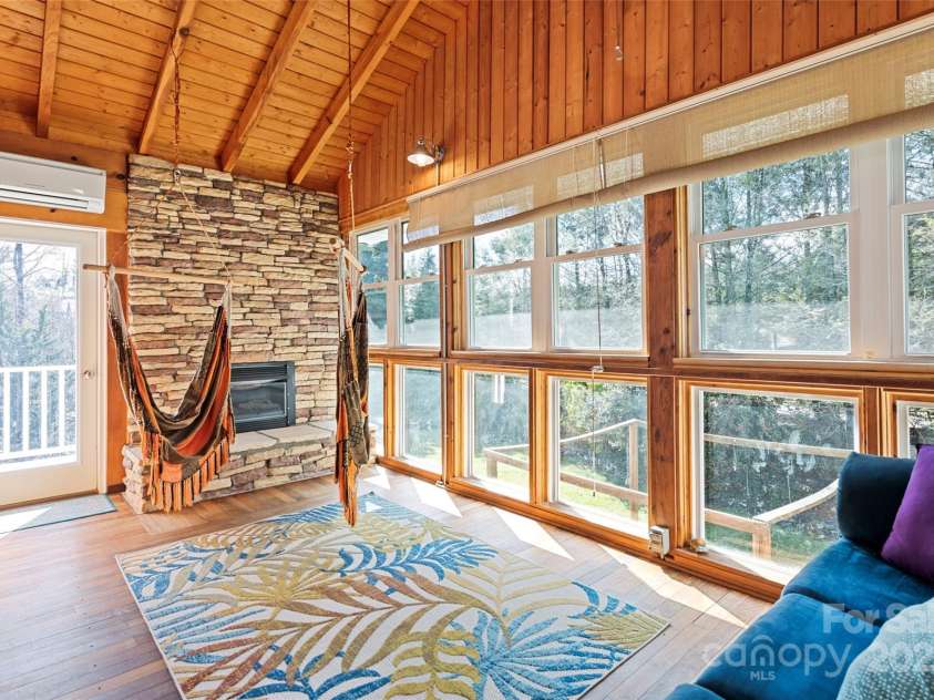 149 Southbrook Lane, Fletcher, NC 28732.  MLS# CAR4221393, YatesRealty ID 15918. Just off the great room is a 4 season vaulted space with a gas fireplace and windows to give the effect of being in a tree house.