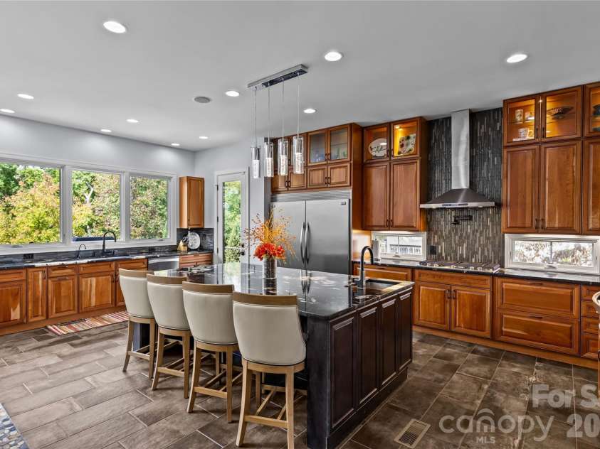 6032 Headlands Court, Belmont, NC 28012.  MLS# CAR4302643, YatesRealty ID 15936. Stunning chef's kitchen has cherry & maple cabinets, granite countertops, oversized kitchen island, dual built-in stainless steel Frigidaire refrigerator & freezer, stainless steel appliances, prep sink in kitchen islan