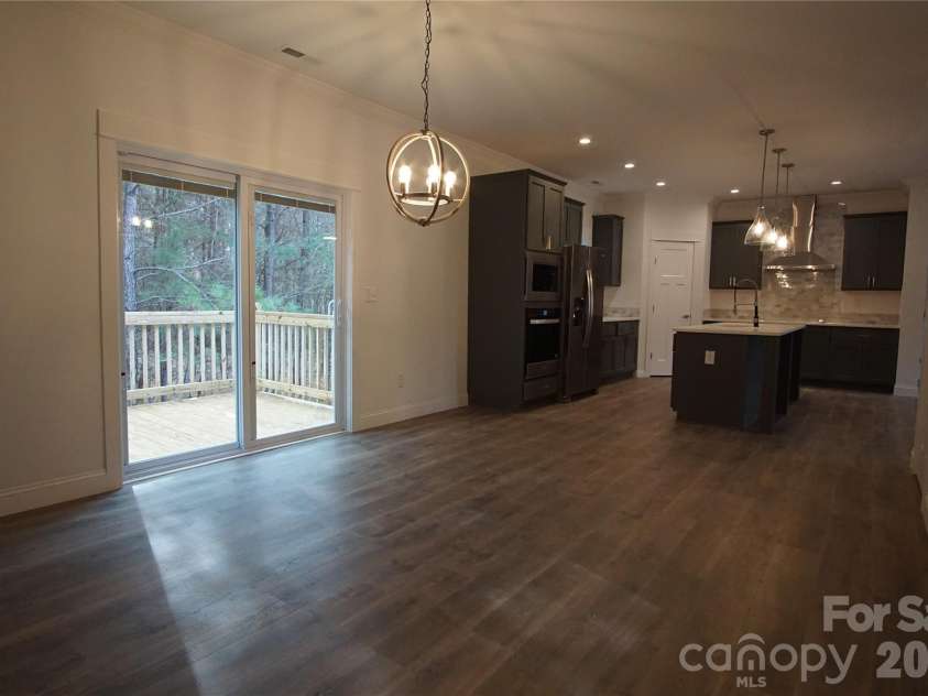 274 Quail Hill Drive, Rutherfordton, NC 28139.  MLS# CAR4322920, YatesRealty ID 15939. Dining area looking back to kitchen and deck