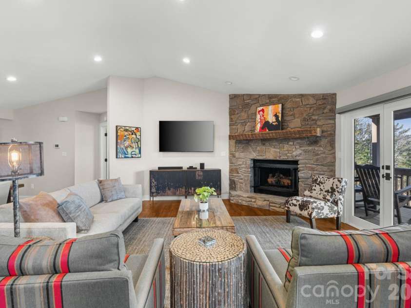 3302 Timber Trail, Asheville, NC 28804.  MLS# CAR4333678, YatesRealty ID 15948. Den opens out onto a deck that spans the entire top floor.