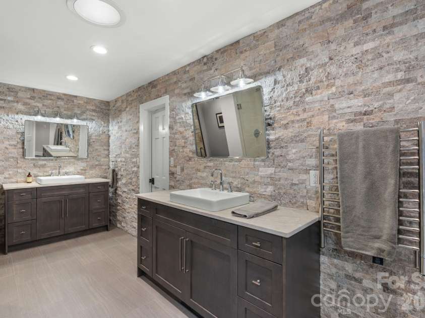 3302 Timber Trail, Asheville, NC 28804.  MLS# CAR4333678, YatesRealty ID 15948. Double vanities in primary bath with heated towel rack