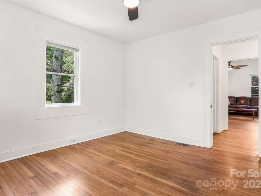 17 Springdale Avenue, Asheville, NC 28803.  MLS# CAR4261466, YatesRealty ID 15949. Generously sized guest room with wood floors