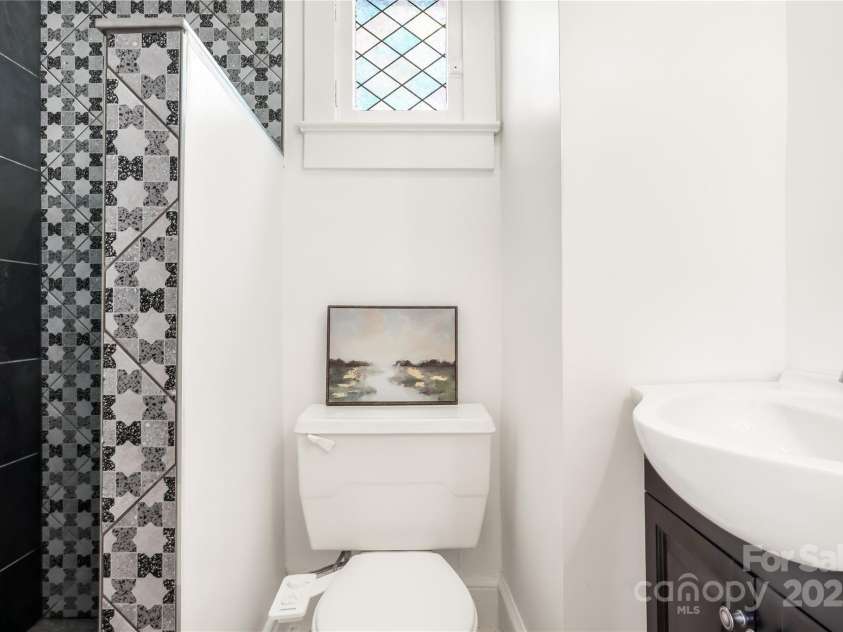 17 Springdale Avenue, Asheville, NC 28803.  MLS# CAR4261466, YatesRealty ID 15949. Tiled shower and clean finishes in the ensuite bath