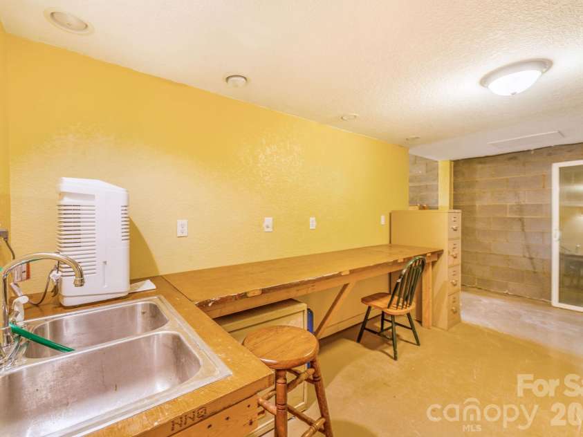 22 Mountain Spring Lane, Canton, NC 28716.  MLS# CAR4346093, YatesRealty ID 15957. Workshop space in unfinished lower level