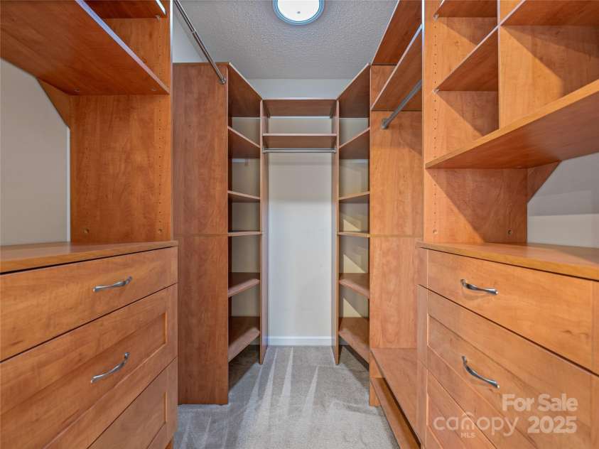 106 Thistle Tree Way, Weaverville, NC 28787.  MLS# CAR4315320, YatesRealty ID 15965. Primary Suite Walkin closet with builtin drawers and shevles