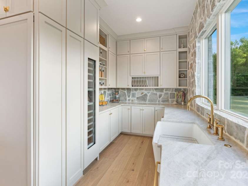 7679 Rabbit Circle, Denver, NC 28037.  MLS# CAR4248734, YatesRealty ID 15997. Thoughtful open walk-in pantry offering prep area, 2 dishwashers, and beverage fridge.