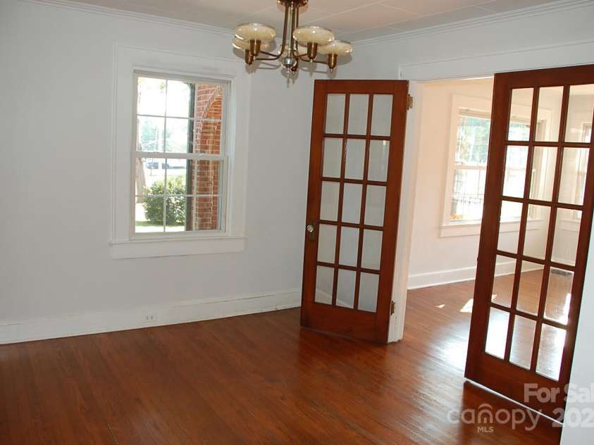 2124 Main Street, Albemarle, NC 28001.  MLS# CAR4188559, YatesRealty ID 15998. Dining room adjoins kitchen with hardwood floors and French doors that open into Living Room