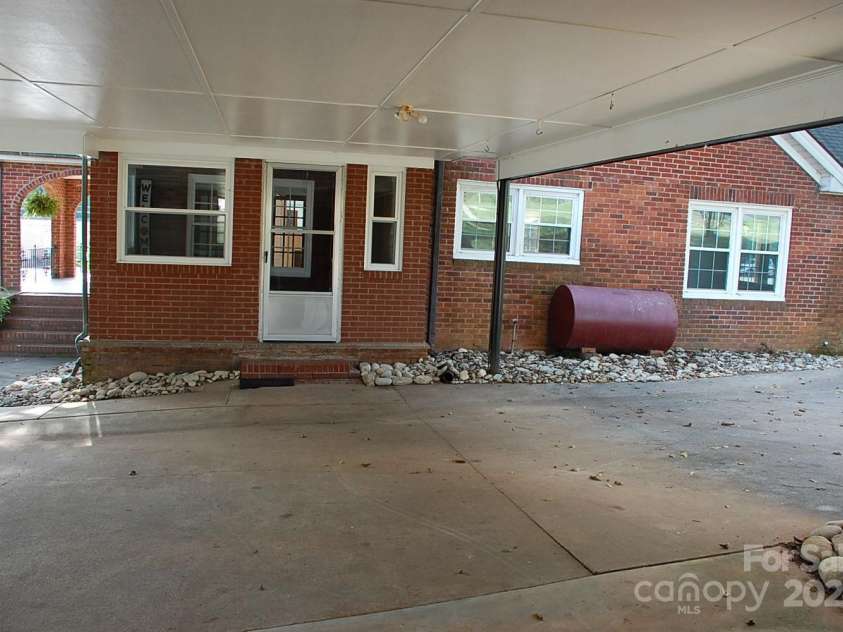 2124 Main Street, Albemarle, NC 28001.  MLS# CAR4188559, YatesRealty ID 15998. View of rear entrance from connected garage and covered drive thru carport
