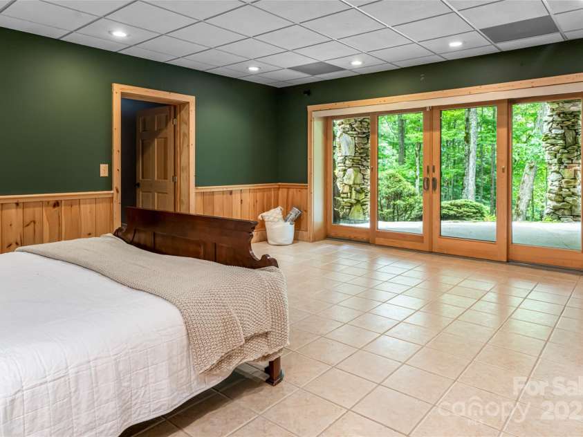 303 Flying Hawk Trail, Waynesville, NC 28786.  MLS# CAR4272138, YatesRealty ID 160. 2nd bedroom with terrace level exterior access (lower level driveway allows easy (no steps) access to basement level