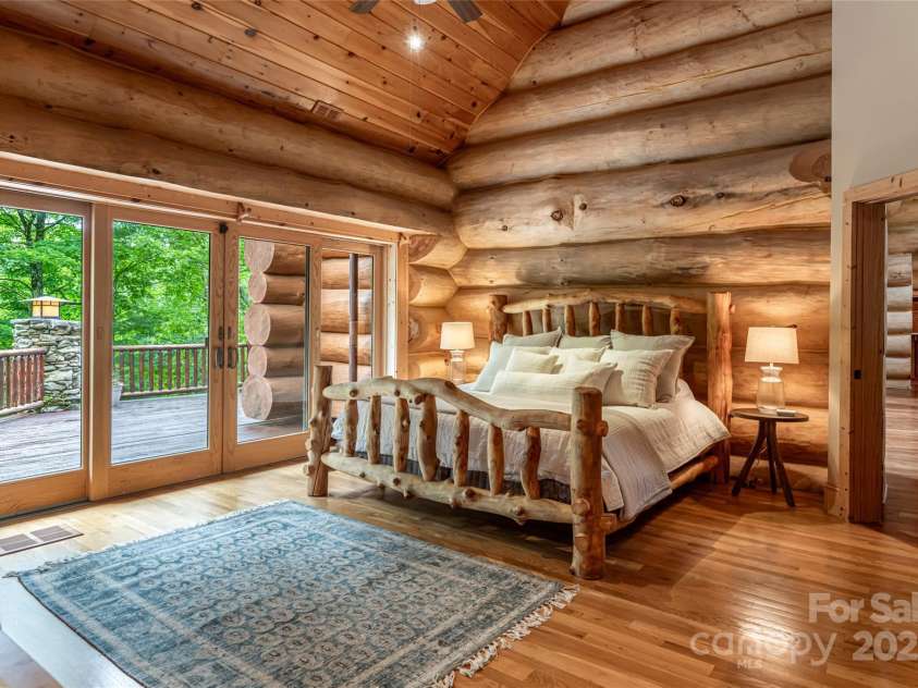 303 Flying Hawk Trail, Waynesville, NC 28786.  MLS# CAR4272138, YatesRealty ID 160. Primary bedroom on main with deck access and vaulted ceilings