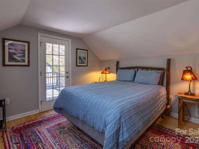 136 Dars Lane, Tuckasegee, NC 28783.  MLS# CAR4248083, YatesRealty ID 1600. Upstairs bedroom with deck