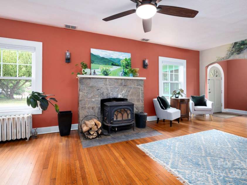 135 Tacoma Circle, Asheville, NC 28801.  MLS# CAR4259347, YatesRealty ID 16015. Living Room with Faux-Stone Surround Wood-Burning Stove