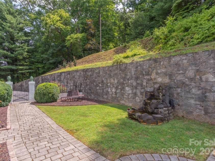 568 Country Club Drive, Waynesville, NC 28786.  MLS# CAR4166222, YatesRealty ID 16019. Impressive rock wall, paved walk ways.