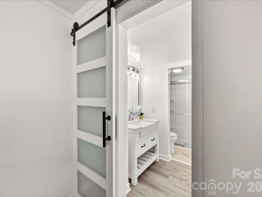 2229 Rexford Road, Charlotte, NC 28211.  MLS# CAR4390305, YatesRealty ID 1602. Modern updated bath with separate vanity area and additional storage closet
