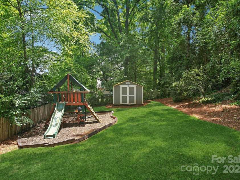 545 Dilworth Mews Court, Charlotte, NC 28203.  MLS# CAR4237335, YatesRealty ID 16023. Huge backyard with storage shed and outdoor storage closet at rear of home AND under balcony at kitchen level.  EASY access too!