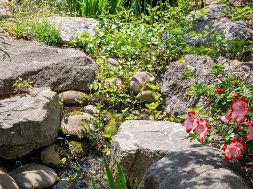 15 Sassy Lane, Asheville, NC 28805.  MLS# CAR4248835, YatesRealty ID 16032. Beautiful stone work and flowers surround a trickling water feature