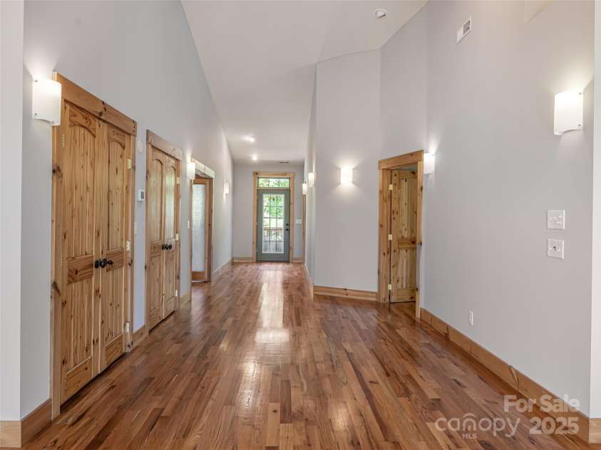 15 Sassy Lane, Asheville, NC 28805.  MLS# CAR4248835, YatesRealty ID 16032. Front door entryway with natural light, solid oak floors, dual storage closets made of pine. Vaulted ceiling gives a feeling of space and openness