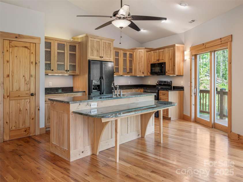 15 Sassy Lane, Asheville, NC 28805.  MLS# CAR4248835, YatesRealty ID 16032. Large, open kitchen with hickory cabinets and pantry. Marble kitchen island with breakfast bar. Sliding doors directly to wrap around deck.