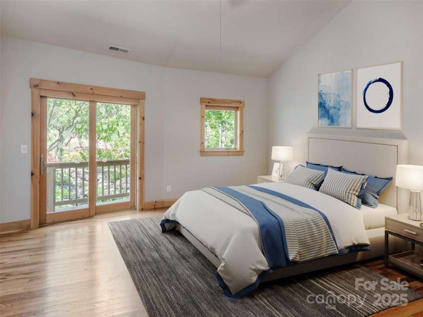 15 Sassy Lane, Asheville, NC 28805.  MLS# CAR4248835, YatesRealty ID 16032. Virtually staged Primary Bedroom with sliding doors to wrap around deck and gardens