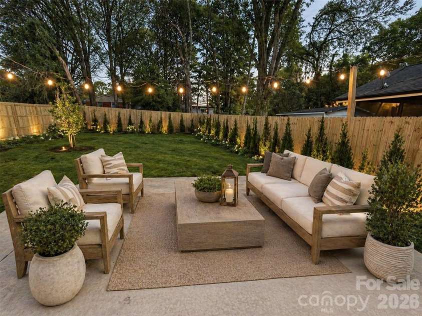 2128 Holly Street, Charlotte, NC 28216.  MLS# CAR4352924, YatesRealty ID 16032. Fenced yard. Bushes and patio furniture are virtually staged