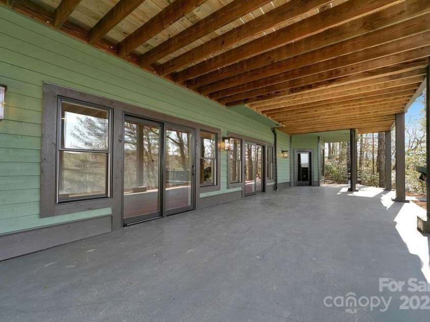 5039 Connestee Trail, Brevard, NC 28712.  MLS# CAR4216573, YatesRealty ID 1604. Lower Covered Patio