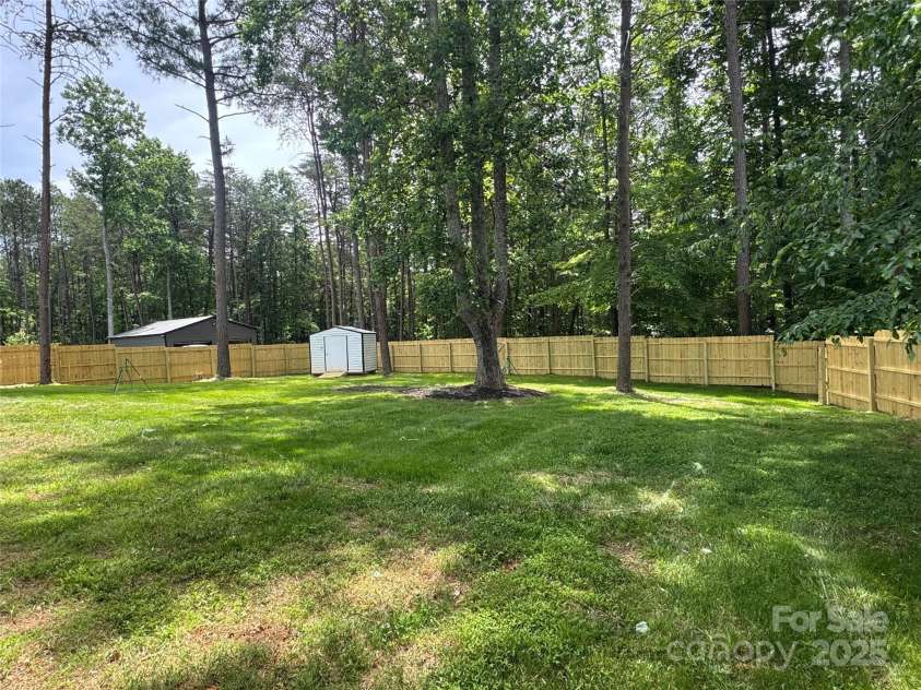 166 Brook Creek Drive, Troutman, NC 28166.  MLS# CAR4239047, YatesRealty ID 16041. Spacious Backyard