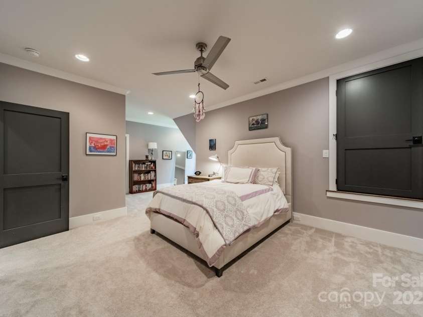 14228 Ryker Way, Davidson, NC 28036.  MLS# CAR4257385, YatesRealty ID 16043. Upper Level bedroom one with hidden flex space behind the door