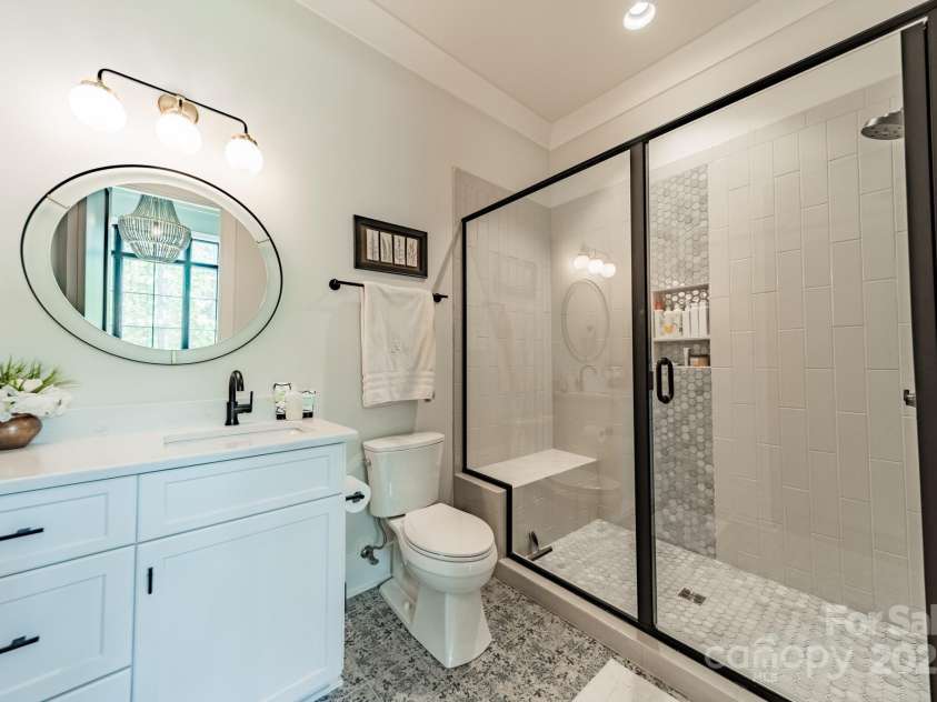 14228 Ryker Way, Davidson, NC 28036.  MLS# CAR4319295, YatesRealty ID 16043. Ensuite guest bathroom on main level
