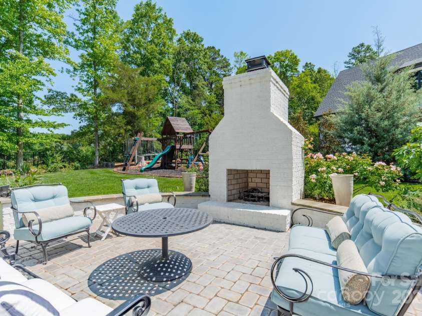 14228 Ryker Way, Davidson, NC 28036.  MLS# CAR4319295, YatesRealty ID 16043. Patio sitting area with wood burning fireplace