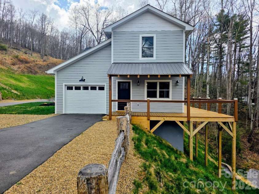 22 Salt Box Haven, Burnsville, NC 28714.  MLS# CAR4364362, YatesRealty ID 16043. 22 Saltbox Haven front view with garage and deck showing