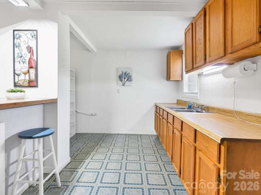 623 School Road, Asheville, NC 28803.  MLS# CAR4365936, YatesRealty ID 16044. Kitchen with 2 sided Breakfast Bar
