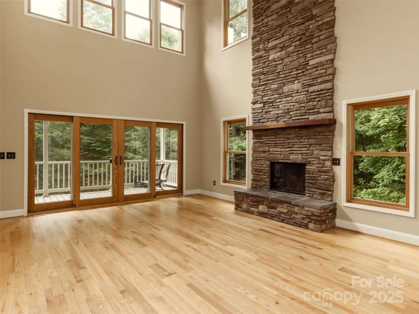 737 Streamside Drive, Arden, NC 28704.  MLS# CAR4248718, YatesRealty ID 16049. An 18 Ft stacked stone fireplace and clerestory windows