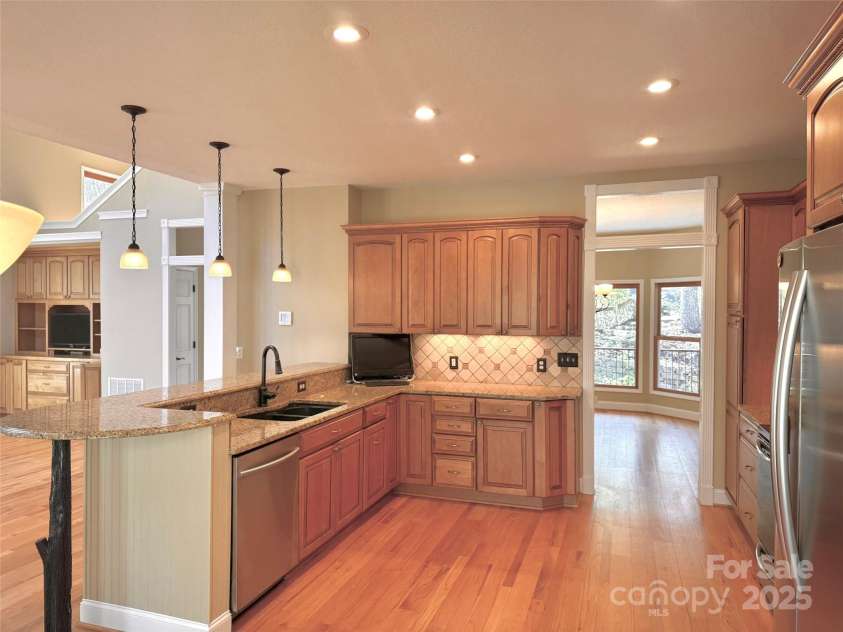 737 Streamside Drive, Arden, NC 28704.  MLS# CAR4248718, YatesRealty ID 16049. Looking through the kitchen toward the dining room