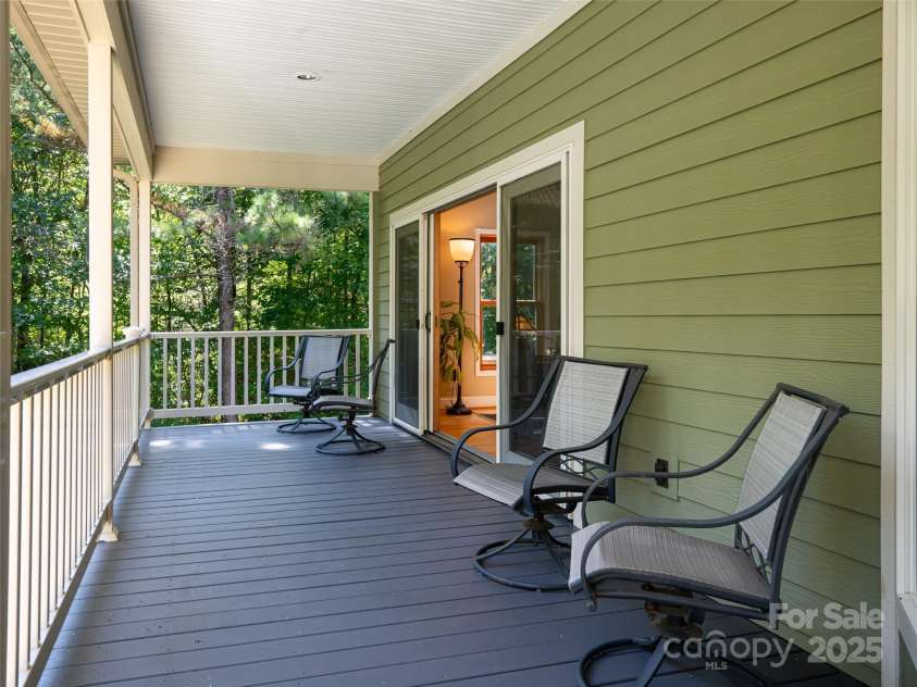 737 Streamside Drive, Arden, NC 28704.  MLS# CAR4248718, YatesRealty ID 16049. The covered porch on the main floor can be accessed from the primary suite or great room and overlooks the back yard