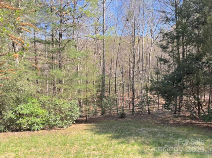 737 Streamside Drive, Arden, NC 28704.  MLS# CAR4248718, YatesRealty ID 16049. The fenced back yard adjoins community woodlands