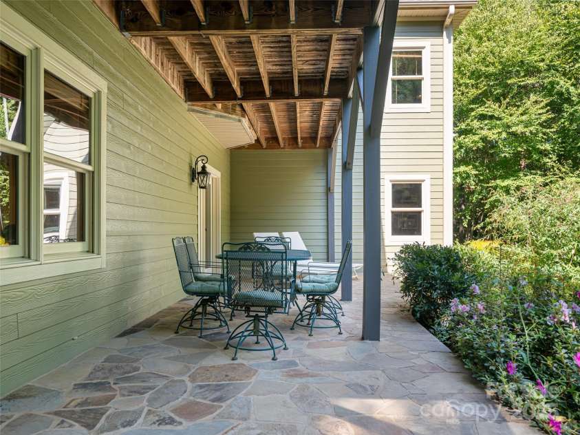 737 Streamside Drive, Arden, NC 28704.  MLS# CAR4248718, YatesRealty ID 16049. The flagstone patio on the lower level is close to 31 ft long