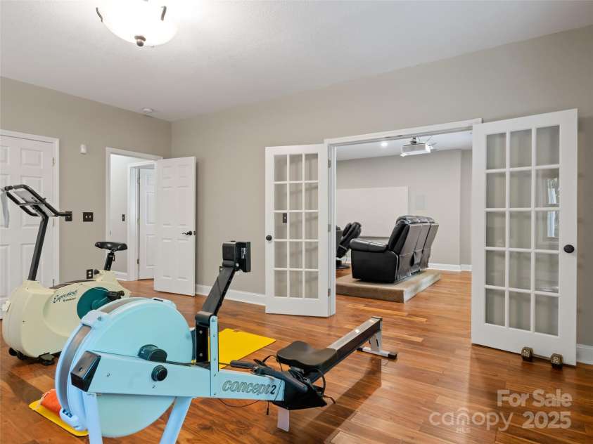 737 Streamside Drive, Arden, NC 28704.  MLS# CAR4248718, YatesRealty ID 16049. The lower level includes two large rooms, a full bath and garage and also has room for a kitchenette. It might be used as a suite. The house has a three bedroom septic permit suitable for 6 full time residents