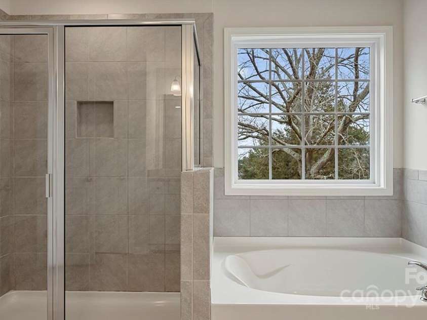 589 Fox Cove Road, Hendersonville, NC 28792.  MLS# CAR4199118, YatesRealty ID 1605. Shower and garden tub in primary bathroom