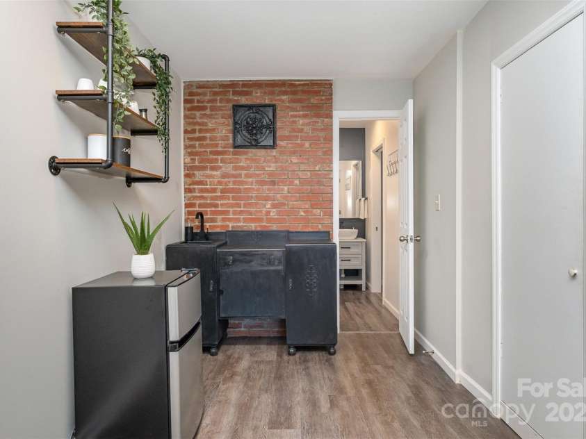 3231 Eastwood Drive, Charlotte, NC 28205.  MLS# CAR4228945, YatesRealty ID 16051. Exposed brick adds charm to this kitchenette sink area