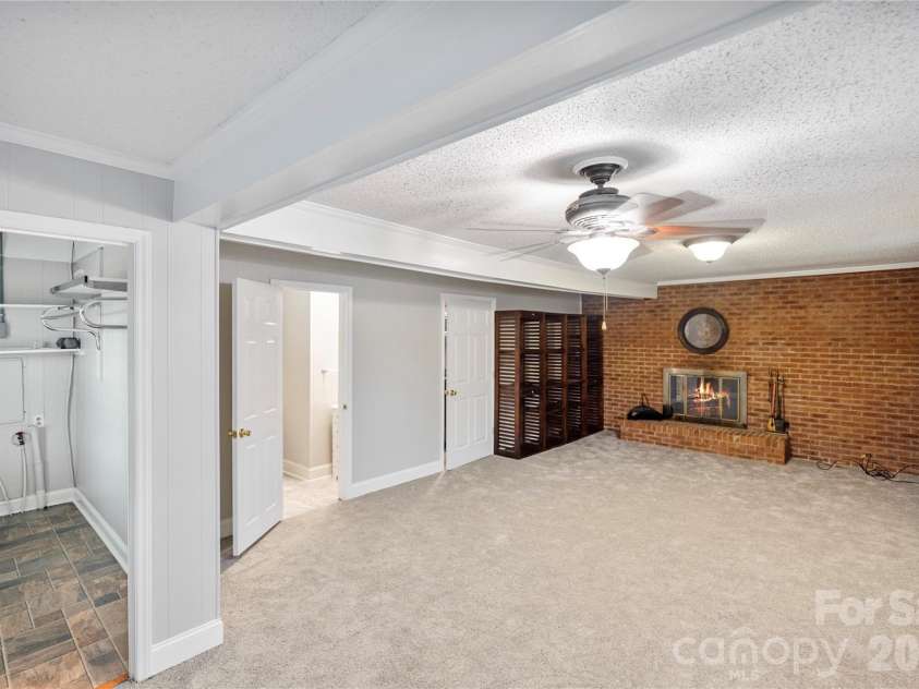 2524 Griffith Road, Monroe, NC 28112.  MLS# CAR4420258, YatesRealty ID 16059. Family Room with Fireplace. This area also has a full bath and Laundry Connections